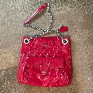 Red, medium sized, authentic coach purse. Front pocket with metal clasp.